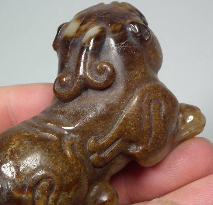 和田白玉带棕褐色沁圆雕大卧兽把件