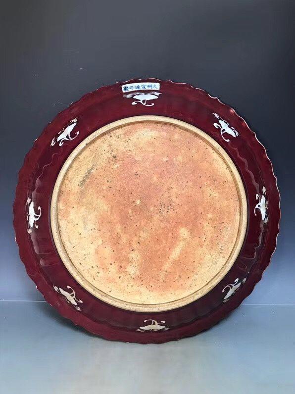 明宣德祭红釉留白折枝花卉纹瓜菱盘